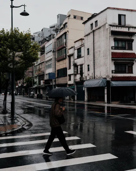 Rainy street photograph after a restrained Classic Chrome film look