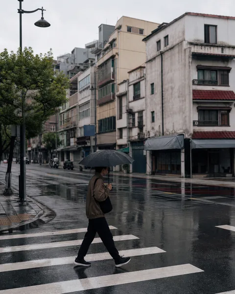 Original rainy street photograph before a Classic Chrome film look